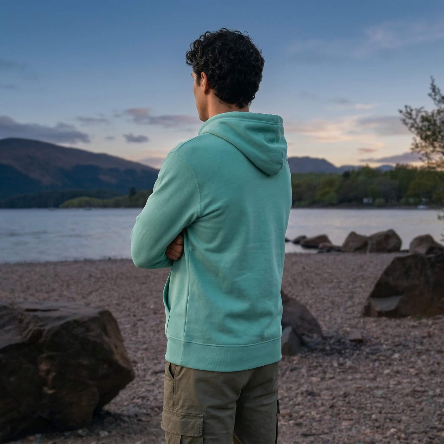 Back view of man wearing teal west highland way map organic cotton hoodie