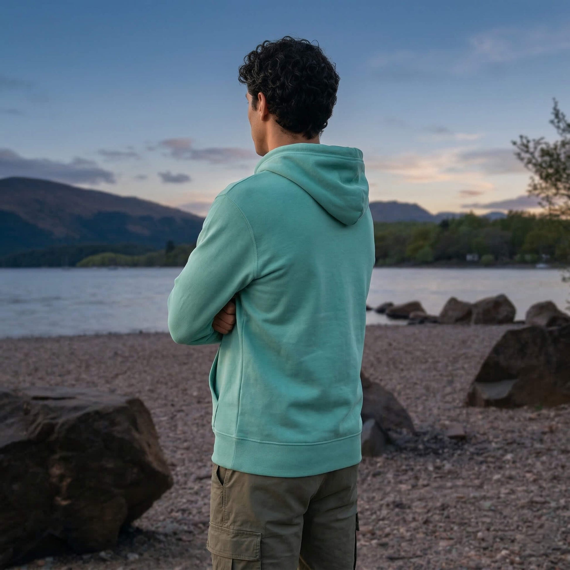 Back view of man wearing teal west highland way map organic cotton hoodie