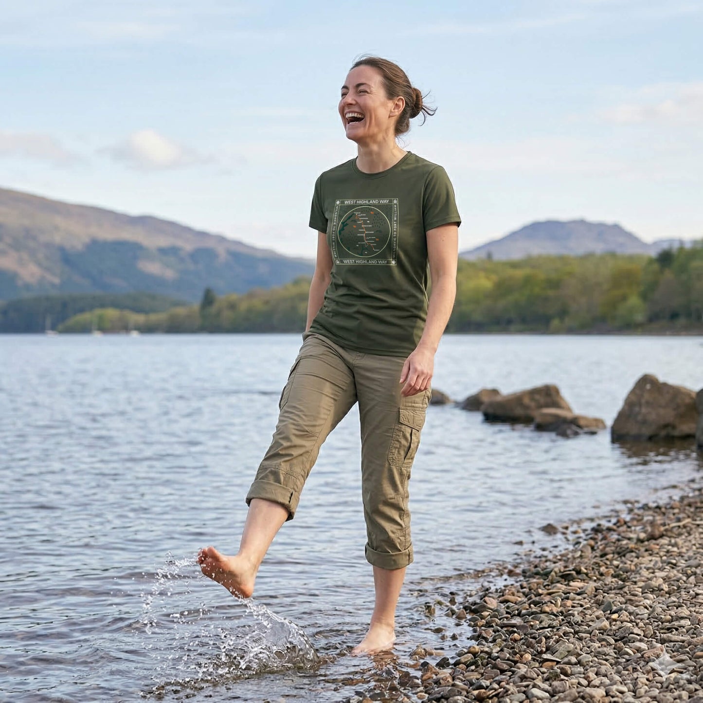 Three quarter view of woman wearing moss green west highland way map tech t-shirt