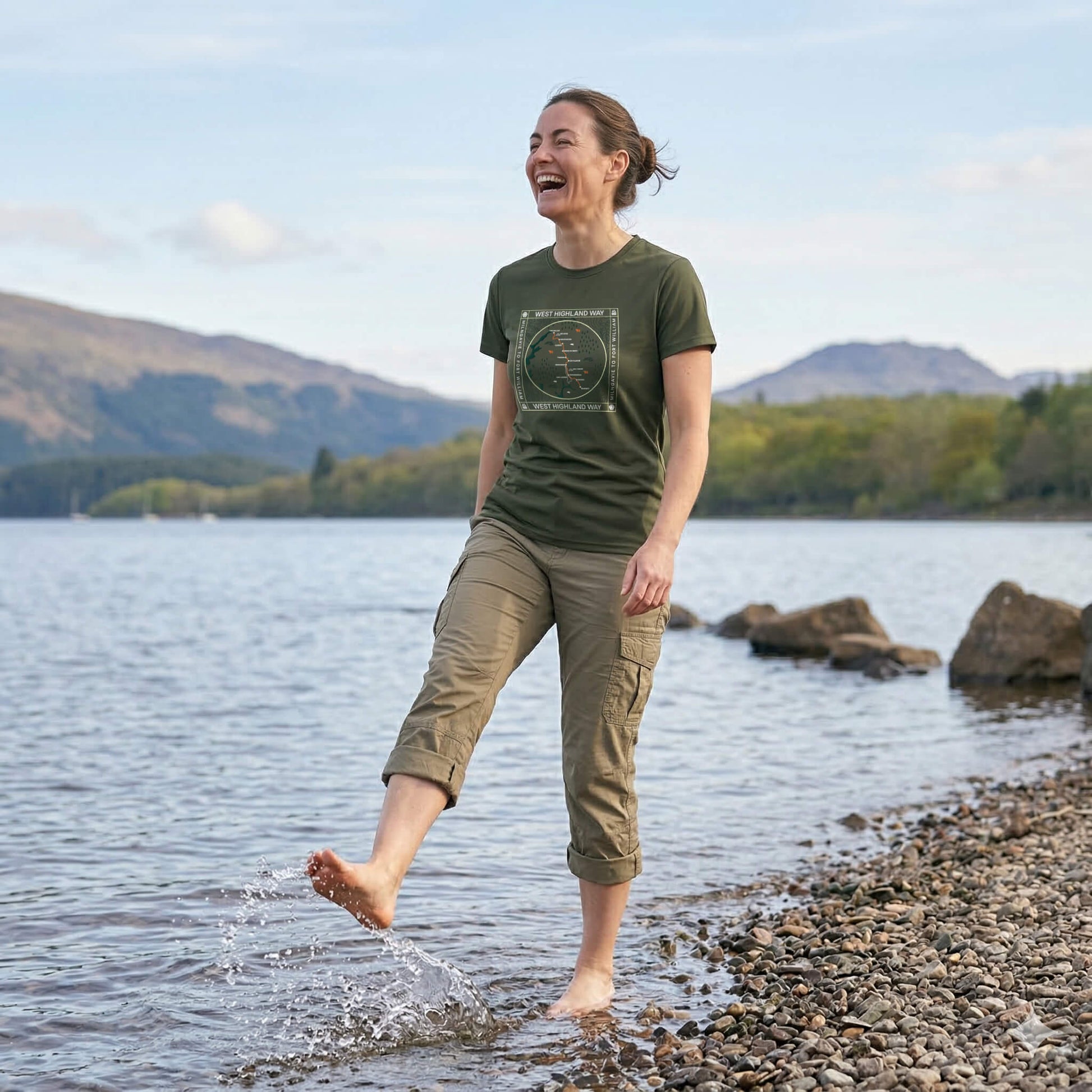 Three quarter view of woman wearing moss green west highland way map tech t-shirt